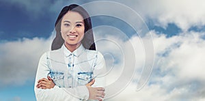 Composite image of asian woman with arms crossed smiling