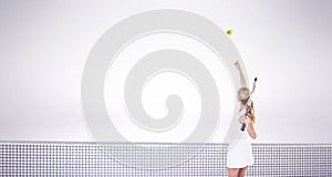 Composite image of athlete holding a tennis racquet ready to serve