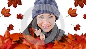 Composite image of attractive brunette looking at camera wearing warm clothes