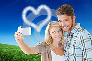 Composite image of attractive couple taking a selfie together