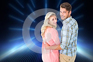 Composite image of attractive couple turning and smiling at camera