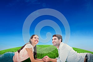 Composite image of attractive young couple looking up