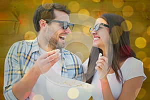 Composite image of attractive young couple watching a 3d movie