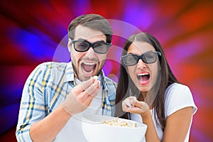 Composite image of attractive young couple watching a 3d movie