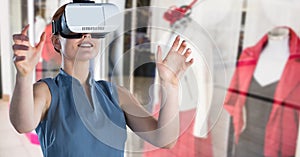 Composite image of aucasian wearing vr headset against boutique in background