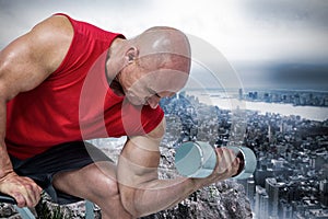 Composite image of bald man exercising with dumbbells while sitting on bench press