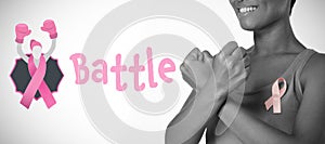 Composite image of battle text with female likeness and breast cancer awareness ribbon