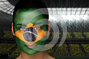 Composite image of beautiful brasil fan in face paint