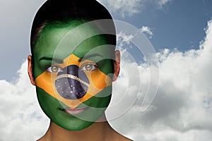 Composite image of beautiful brunette in brasil facepaint