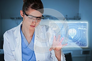 Composite image of beautiful female scientist using digital screen 3d