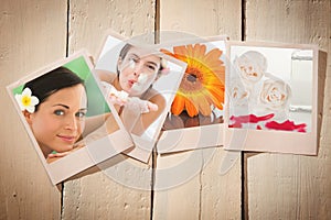 Composite image of beautiful happy woman blowing flower petals at spa center