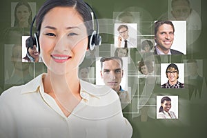 Composite image of beautiful smiling female executive with headset