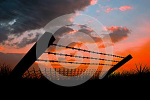 Composite image of bended barbed wire and chainlink fence against white background 3d