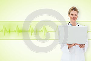 Composite image of blonde doctor using laptop