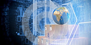 Composite image of blue globe on brown cardboard boxes