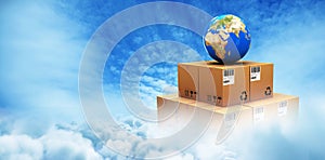 Composite image of blue globe on cardboard boxes