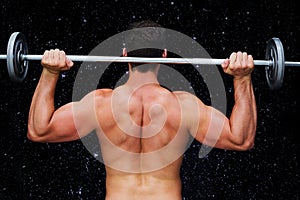 Composite image of bodybuilder lifting barbell