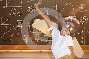 Composite image of boy playing as an aviator at park