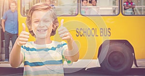 Composite image of boy showing thumbs up while smiling