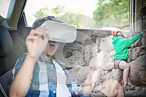 Composite image of boy using virtual reality headset