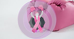 Composite image of breast cancer awareness ribbon with boxing gloves on white table with copy space