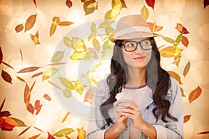 Composite image of brunette with disposable cup