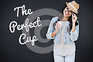 Composite image of brunette with disposable cup