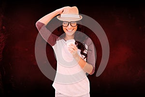 Composite image of brunette with disposable cup