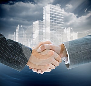 Composite image of business handshake