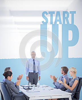 Composite image of business people applauding during meeting