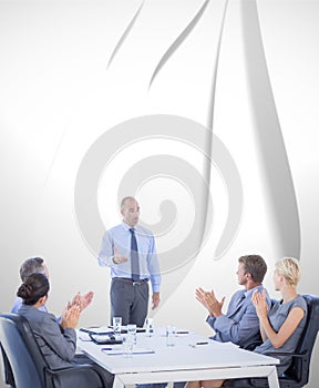 Composite image of business people applauding during meeting