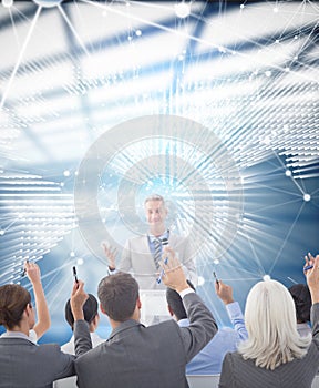 Composite image of business people raising their arms during meeting