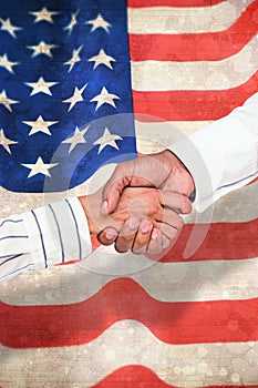 Composite image of business people shaking hands