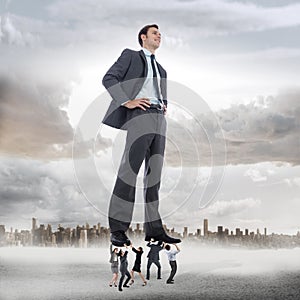 Composite image of business team supporting boss