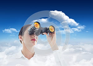Composite image of business woman looking through binoculars