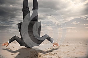 Composite image of businessman burying his head