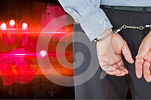 Composite image of businessman in formals with handcuffs