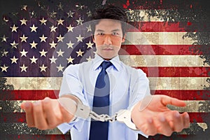 Composite image of businessman with handcuffs