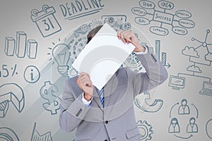 Composite image of businessman holding blank sign in front of his head