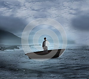 Composite image of businessman holding his jacket in a sailboat