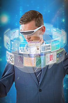 Composite image of businessman imagining while using virtual reality glasses 3d