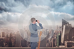 Composite image of businessman looking on a ladder
