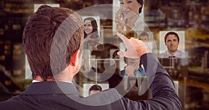 Composite image of businessman pointing with his finger