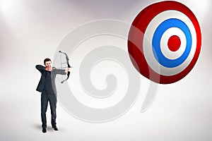 Composite image of businessman shooting a bow and arrow