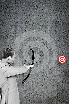 Composite image of businessman shooting target