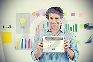 Composite image of businessman showing digital tablet with blank screen in creative office