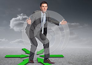 Composite image of businessman standing with arms out