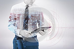 Composite image of businessman using digital tablet 3d