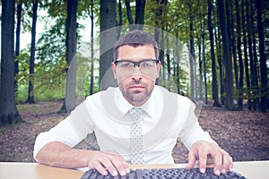 Composite image of businessman working at his desk