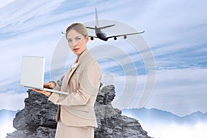 Composite image of businesswoman with a laptop